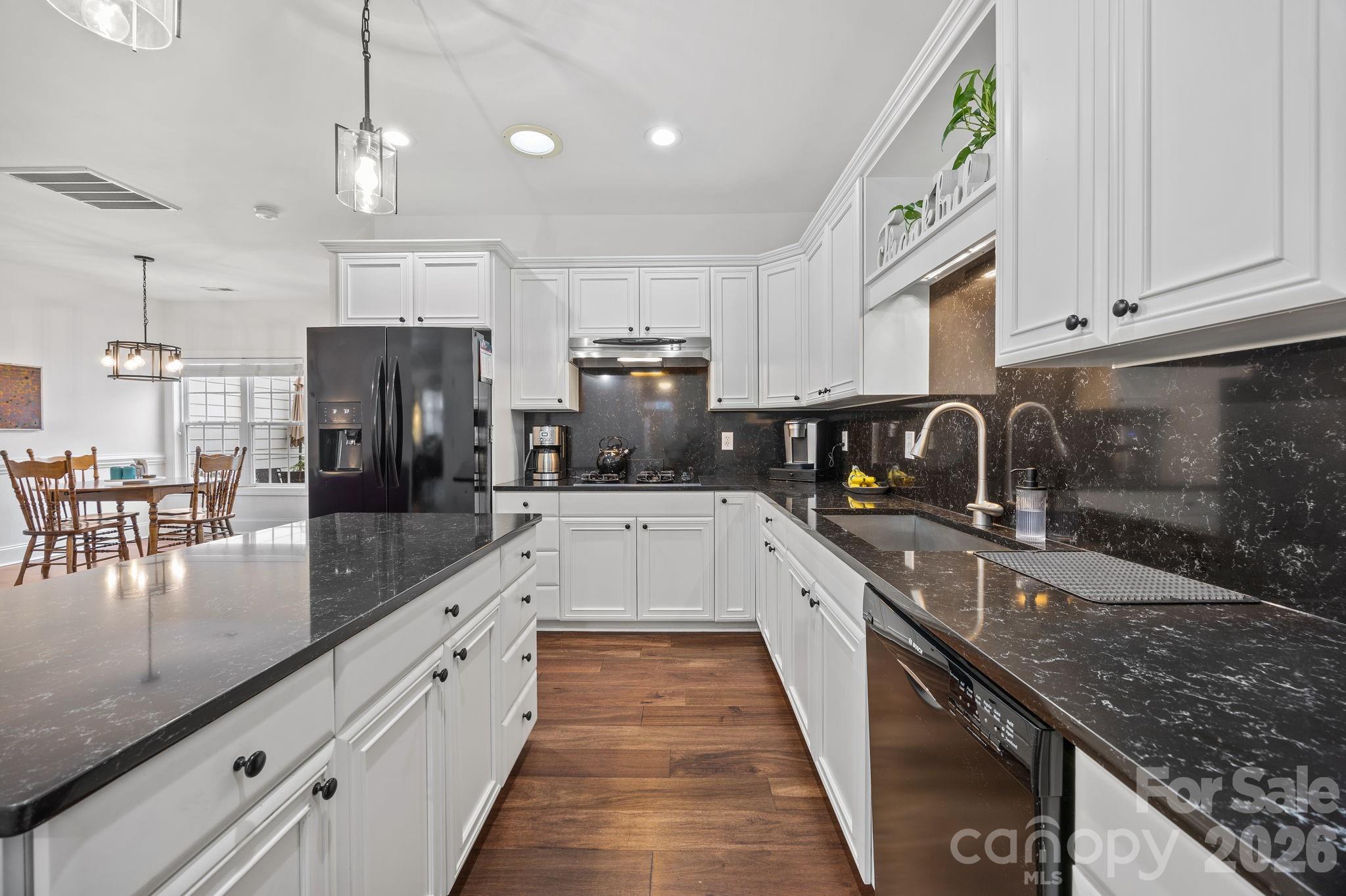 233 Twain Avenue Davidson, NC 28036 - Photo 11 of 35 a large kitchen with granite countertop lots of counter space and stainless steel appliances