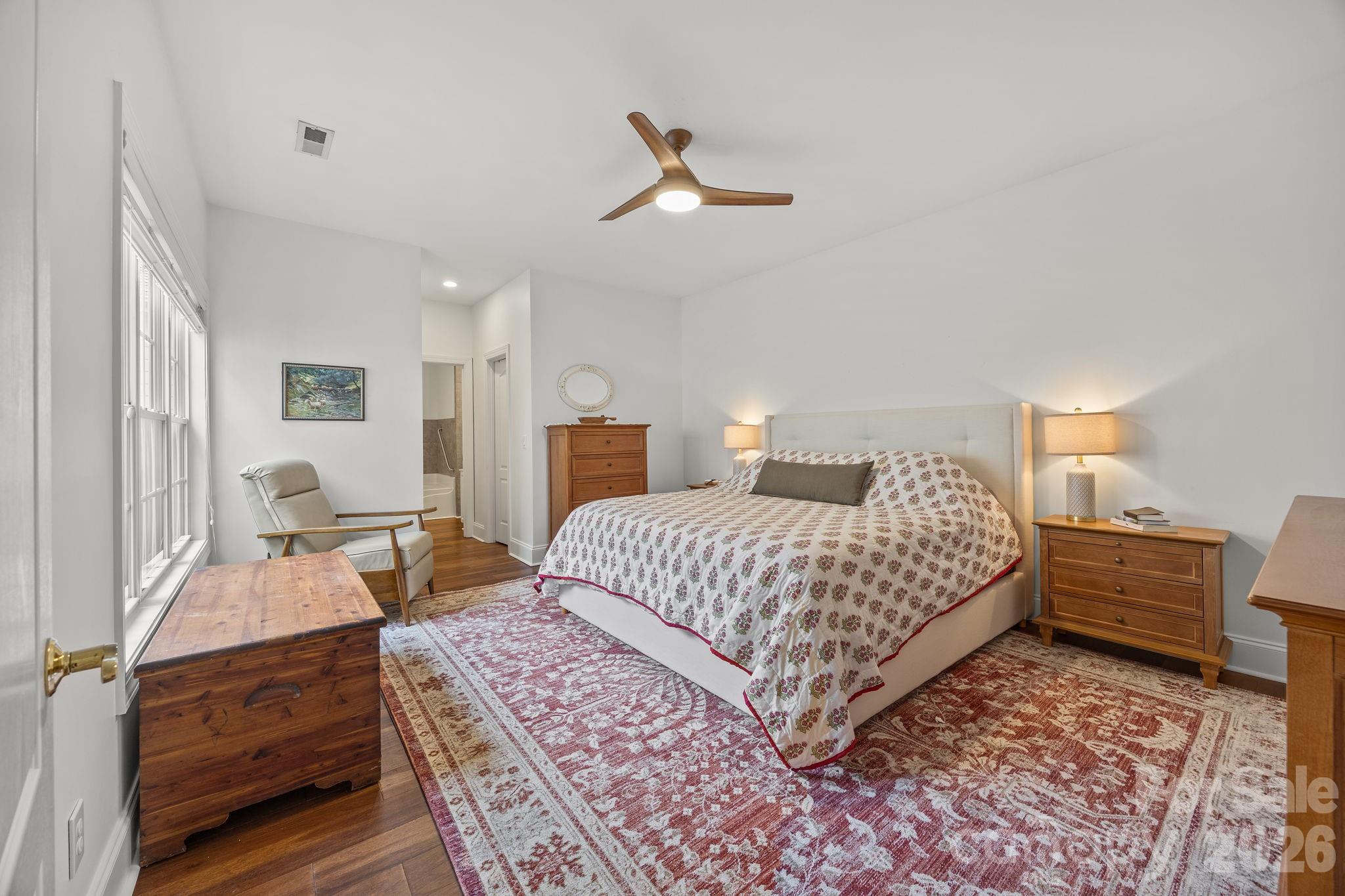 233 Twain Avenue Davidson, NC 28036 - Photo 15 of 35 a bedroom with a large bed and a chandelier