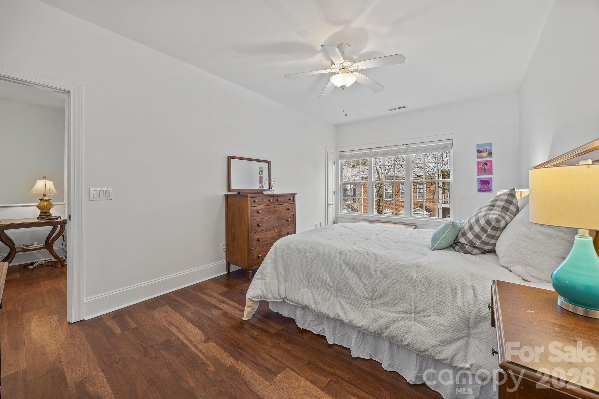 233 Twain Avenue Davidson, NC 28036 - Photo 23 of 35 a bedroom with a large bed and a chandelier