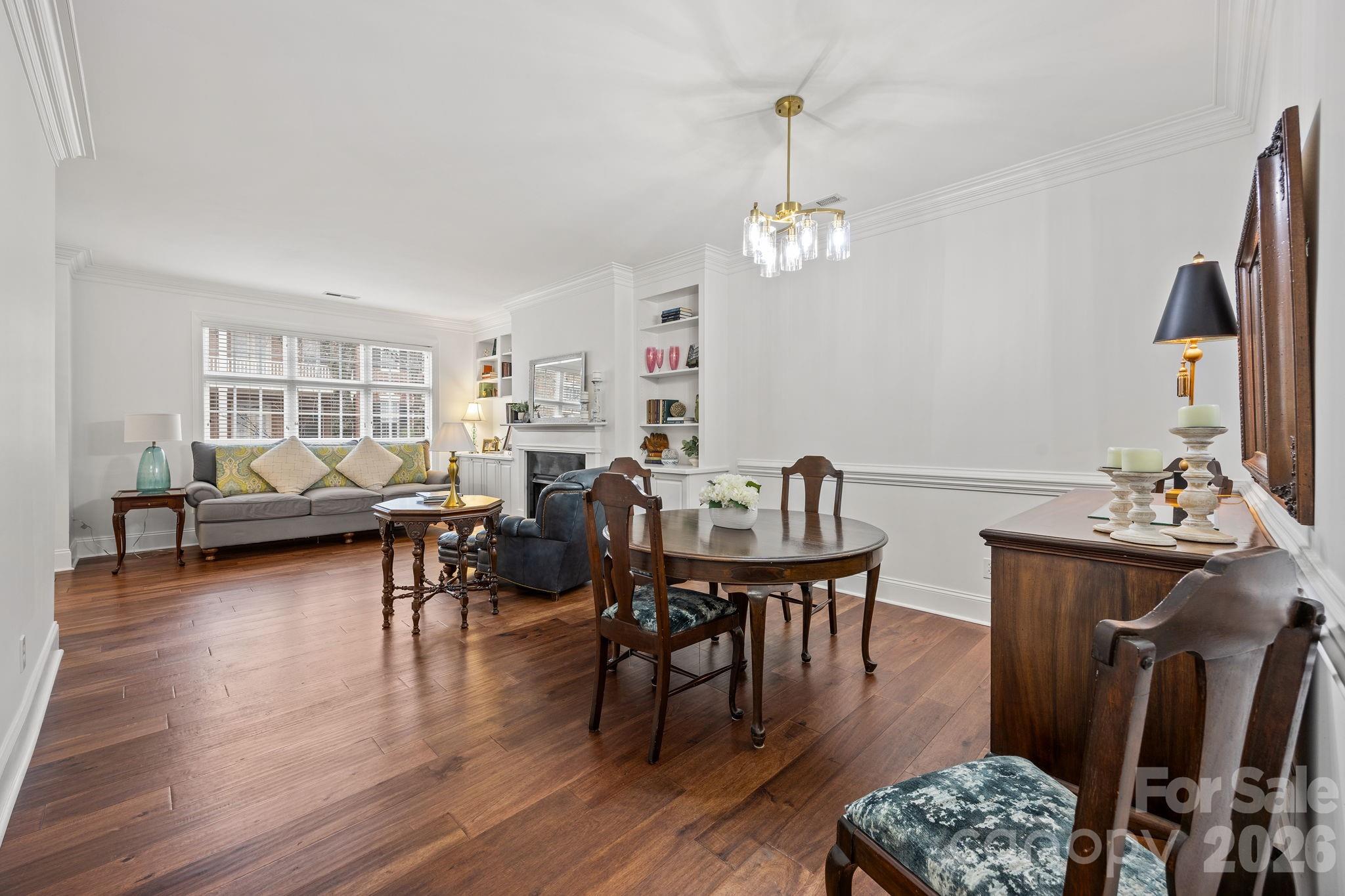 233 Twain Avenue Davidson, NC 28036 - Photo 6 of 35 a living room with furniture a rug and a chandelier