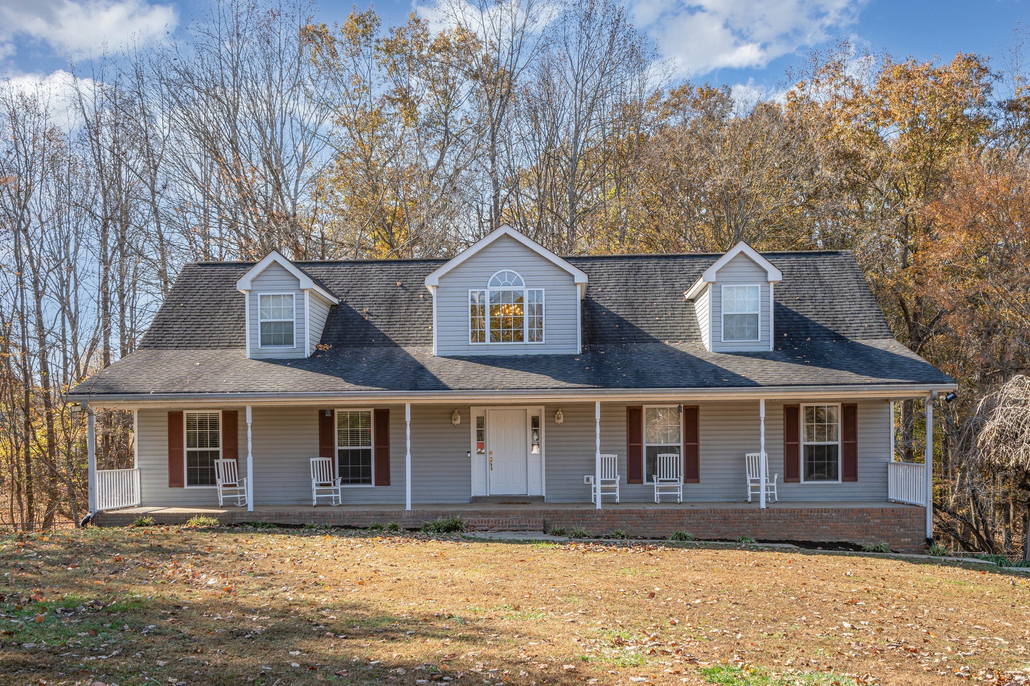 a view of a brick house with a yard
