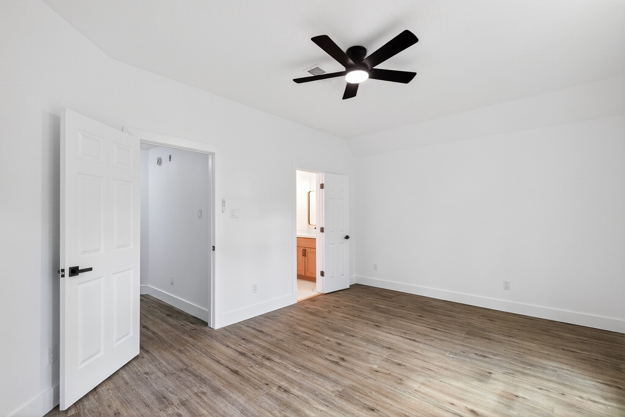 523 Rampart Lane Conroe, TX 77302 - Photo 23 of 41 Bright secondary bedroom with luxury vinyl plank flooring, generous closet space, and serene views of River Plantation's mature landscape.
