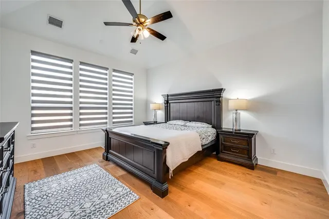 a bedroom with a bed lamp and a dresser