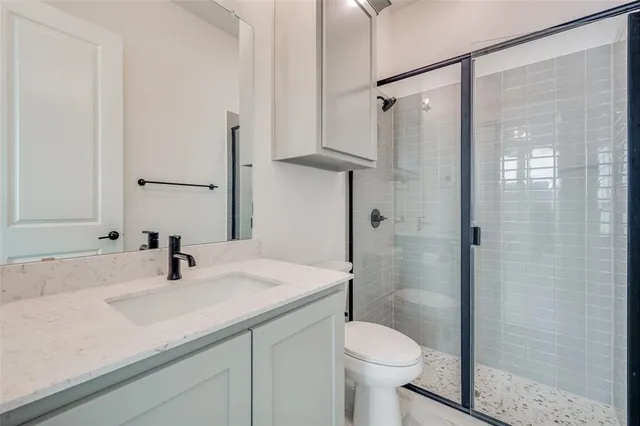 a bathroom with a sink toilet and shower