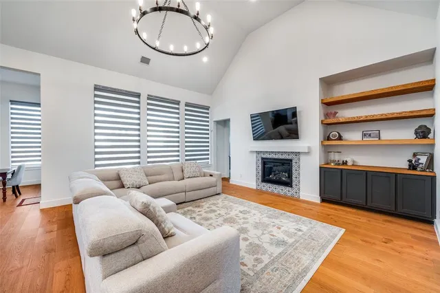 a living room with furniture a fireplace and a flat screen tv