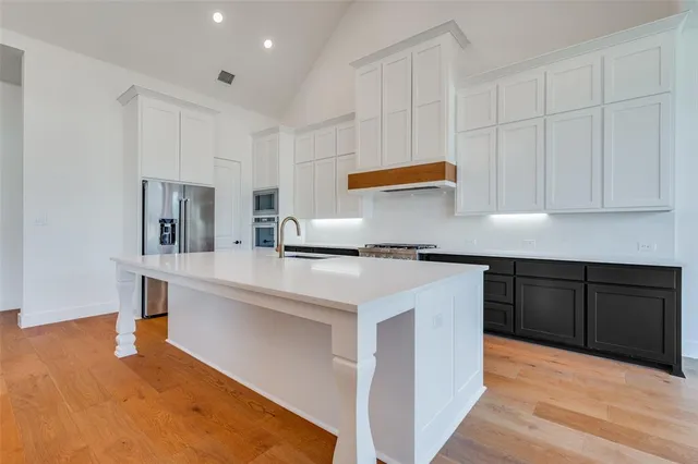 a kitchen with stainless steel appliances granite countertop a sink and cabinets