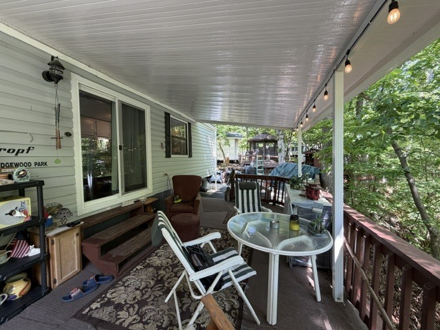 2795 East 28th Road Marseilles, IL 61341 - Photo 18 of 63 a balcony with furniture and wooden floor
