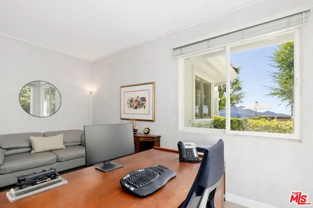 a large kitchen with stainless steel appliances kitchen island granite countertop a stove a sink dishwasher and white cabinets with wooden floor