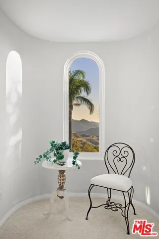 a bedroom with bed and large window