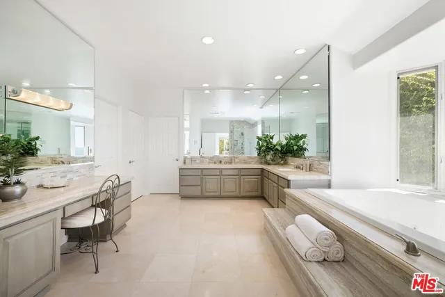 a bedroom with a large bed and a large window