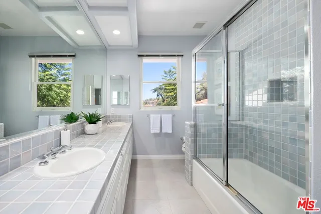 a spacious bedroom with double bed and a couch