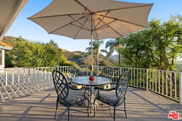 a view of a mountain range with lush green forest