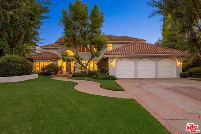 an aerial view of a house with a mountain