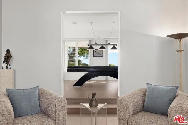 a living room with furniture a flat screen tv and a large window