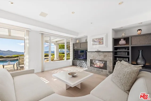 a living room with furniture and large windows