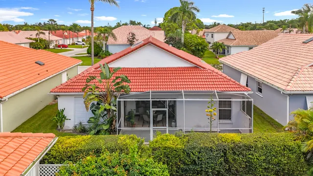a living room with furniture floor to ceiling window and wooden floor