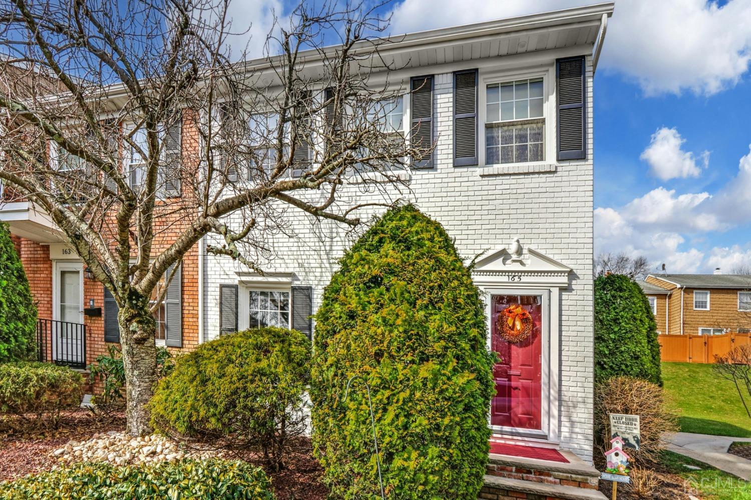 a front view of a house with plants