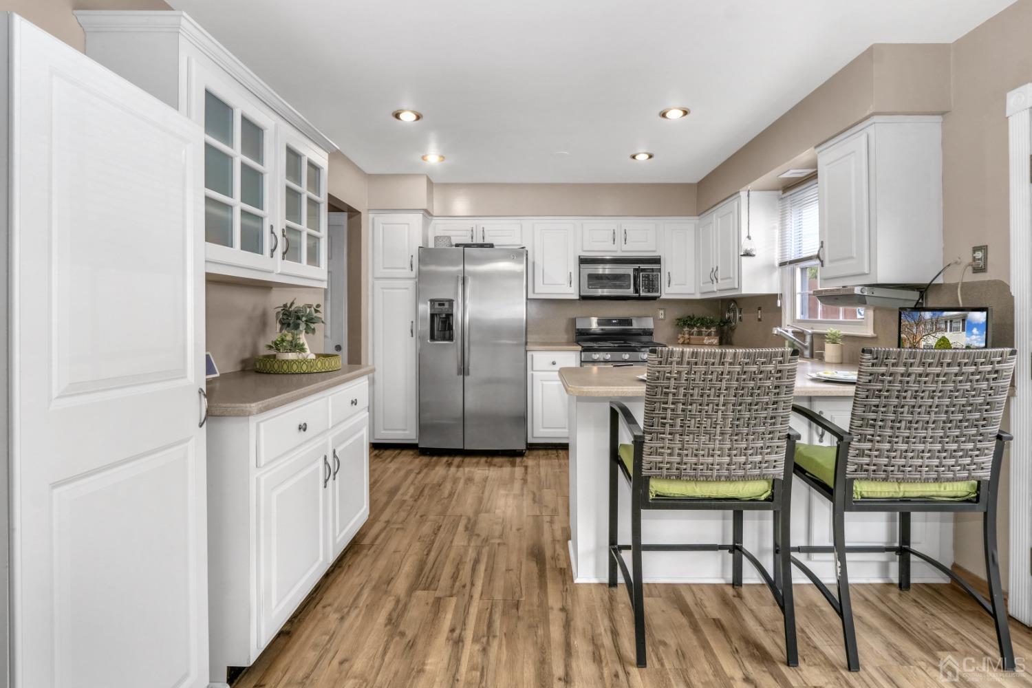 165 Howell Avenue Fords, NJ 08863 - Photo 11 of 31 a kitchen with stainless steel appliances granite countertop a refrigerator and a stove top oven