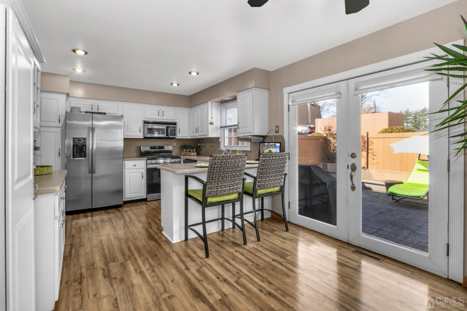 165 Howell Avenue Fords, NJ 08863 - Photo 13 of 31 a kitchen with stainless steel appliances a refrigerator a stove top oven and a sink