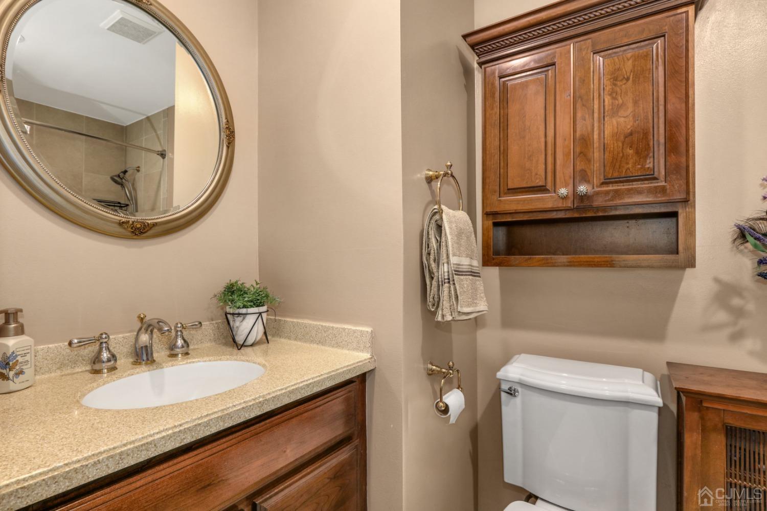 165 Howell Avenue Fords, NJ 08863 - Photo 18 of 31 a bathroom with a granite countertop toilet sink and mirror