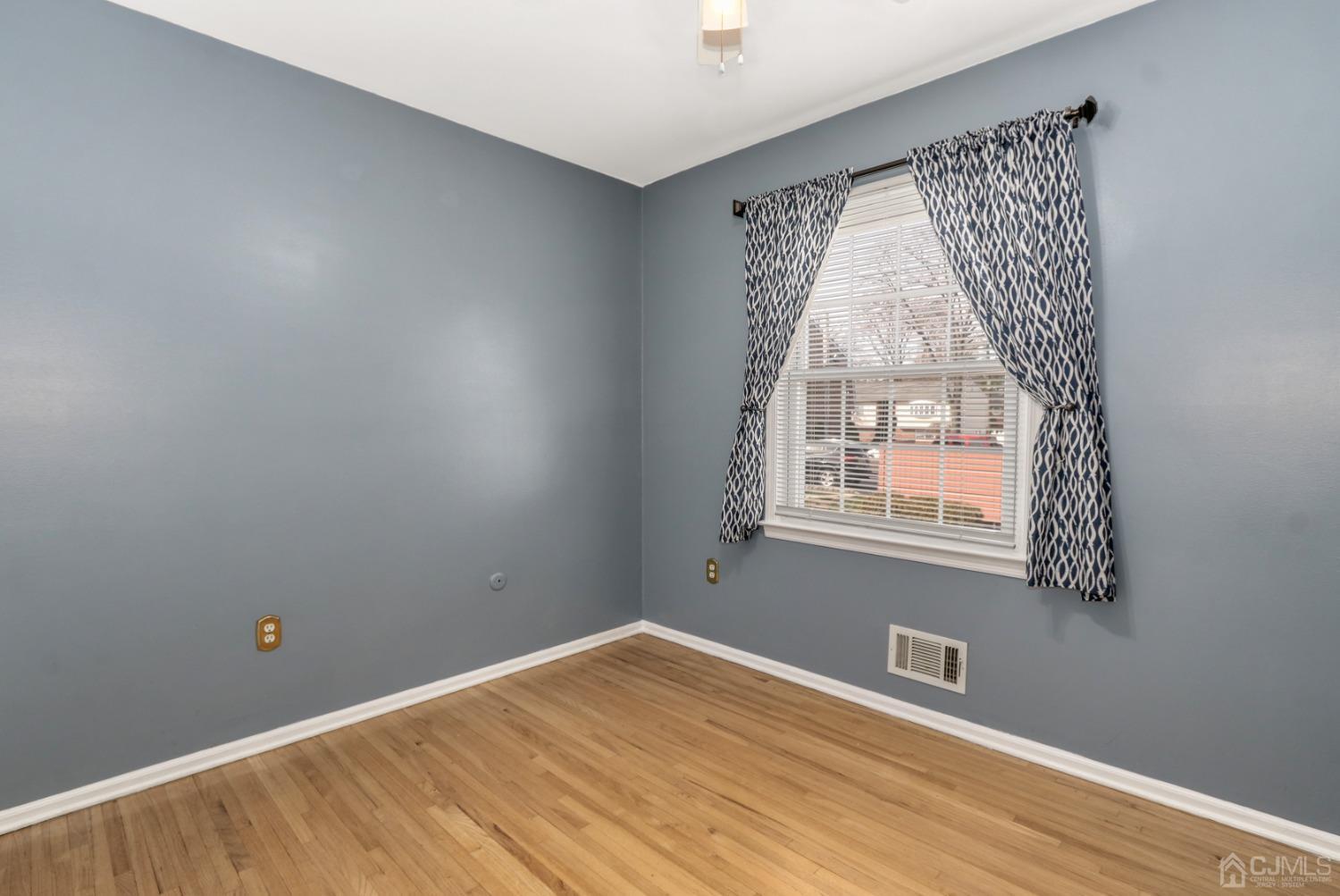 165 Howell Avenue Fords, NJ 08863 - Photo 21 of 31 an empty room with wooden floor and windows