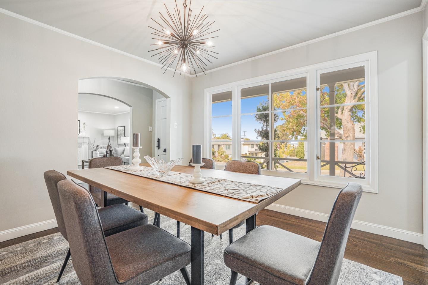100 Chestnut Street San Carlos, CA 94070 - Photo 11 of 45 a view of a dining room and livingroom with furniture wooden floor a rug a potted plant and a chandelier