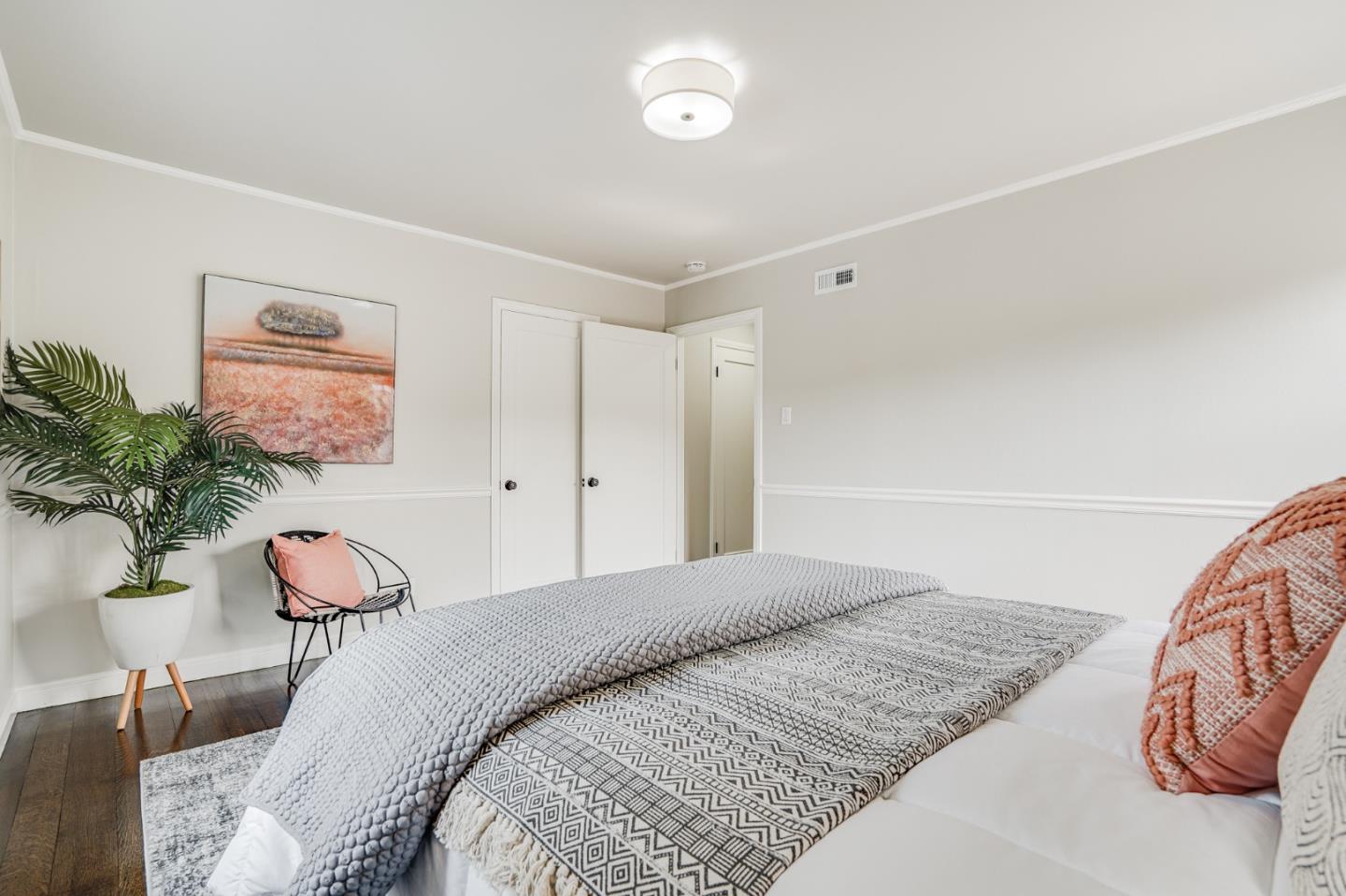 100 Chestnut Street San Carlos, CA 94070 - Photo 25 of 45 a bedroom with a bed and a painting on the wall