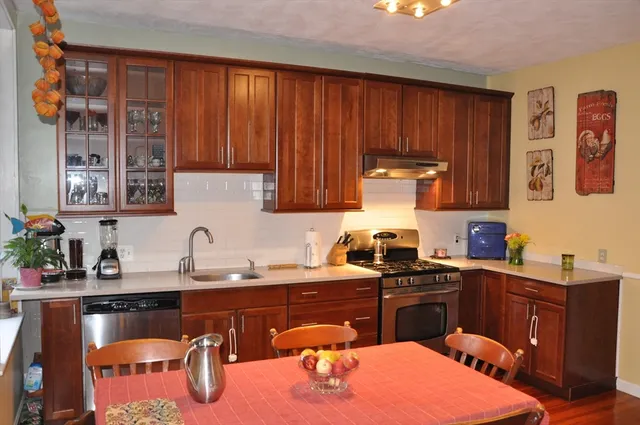 a kitchen with a sink a stove and cabinets