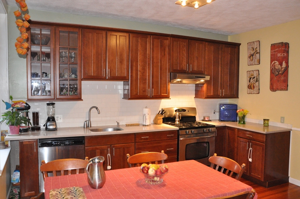 134 Fuller Street, Unit 3 Brookline, MA 02446 - Photo 2 of 8 a kitchen with a sink a stove and cabinets