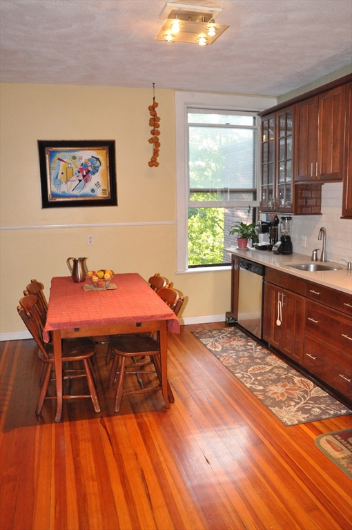 134 Fuller Street, Unit 3 Brookline, MA 02446 - Photo 3 of 8 a kitchen with a sink a window and wooden floor