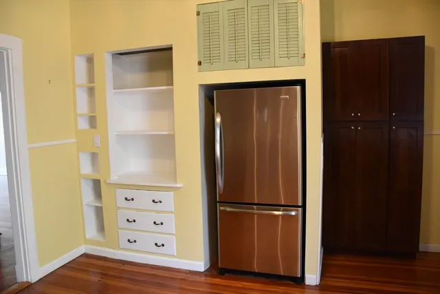 a view of walk in closet with wooden floor
