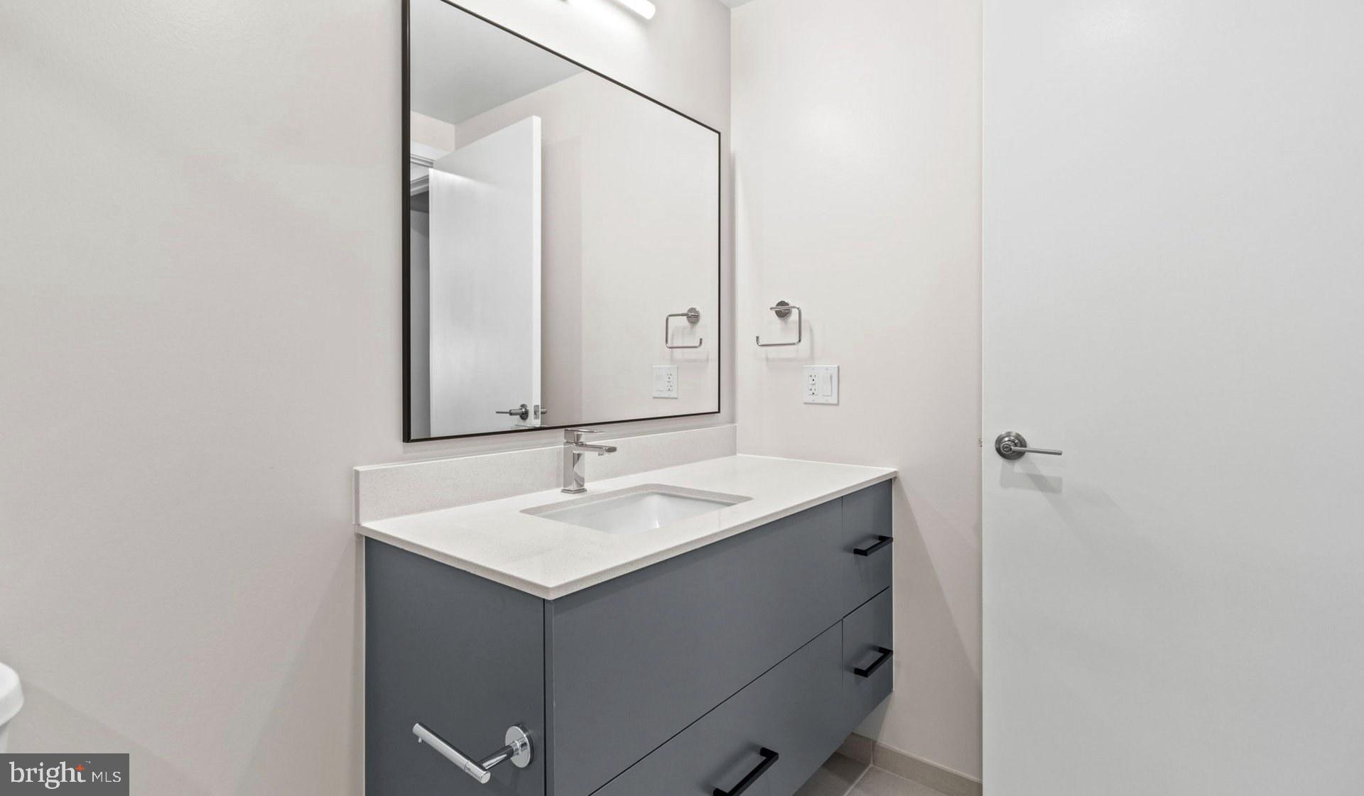 4000 Wisconsin Avenue Northwest, Unit 4K236 Washington, DC 20016 - Photo 42 of 54 a bathroom with a sink and a mirror
