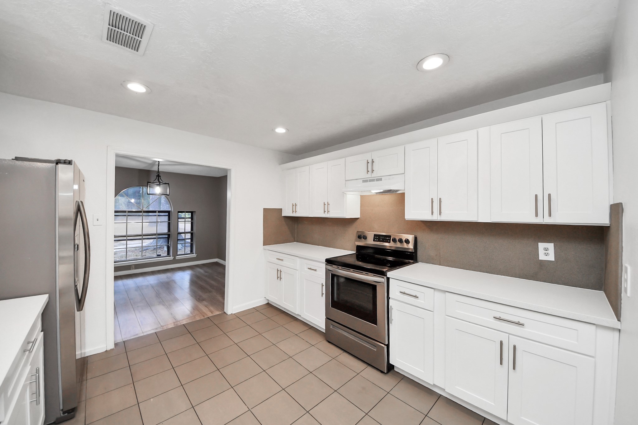 411 Dover Lane Spring, TX 77373 - Photo 17 of 40 a kitchen with granite countertop a sink stainless steel appliances and cabinets