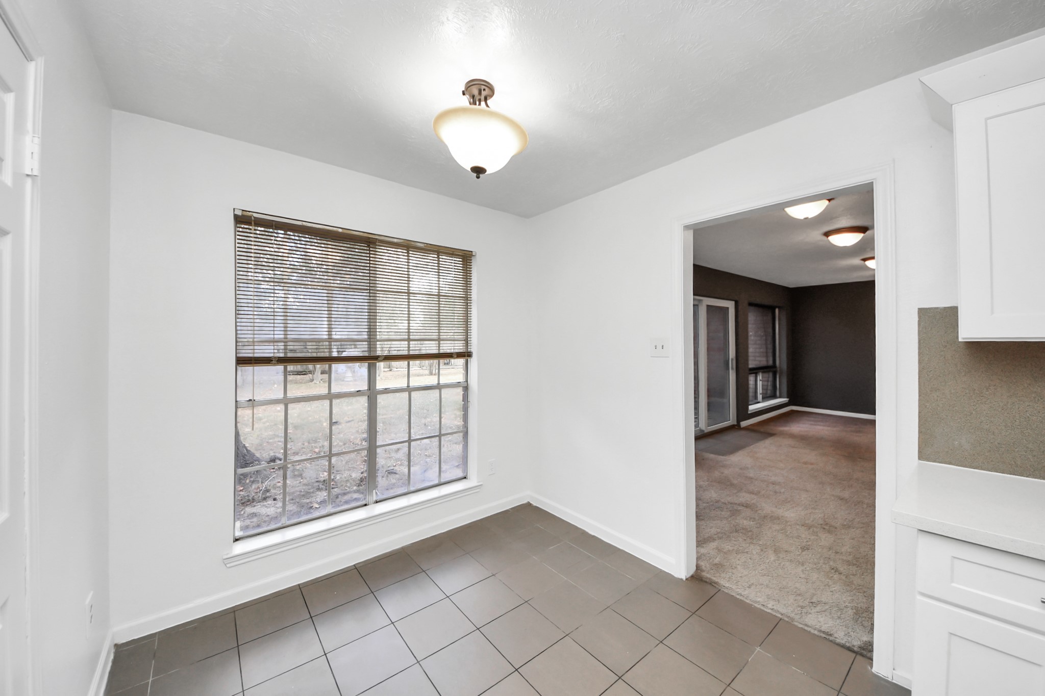411 Dover Lane Spring, TX 77373 - Photo 19 of 40 a view of an empty room with window and wooden floor