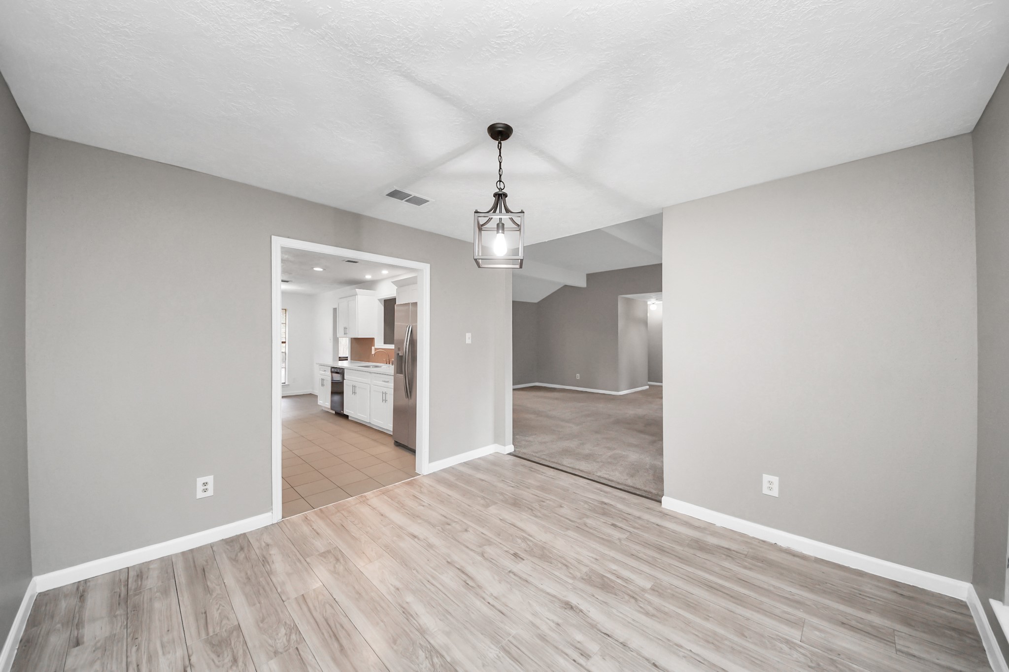 411 Dover Lane Spring, TX 77373 - Photo 20 of 40 a view of a room with wooden floor chandelier and a window