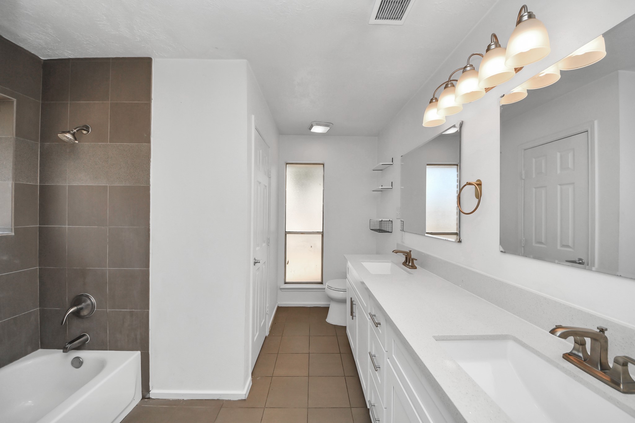 411 Dover Lane Spring, TX 77373 - Photo 27 of 40 a spacious en suite bathroom with a tub double sink and mirror