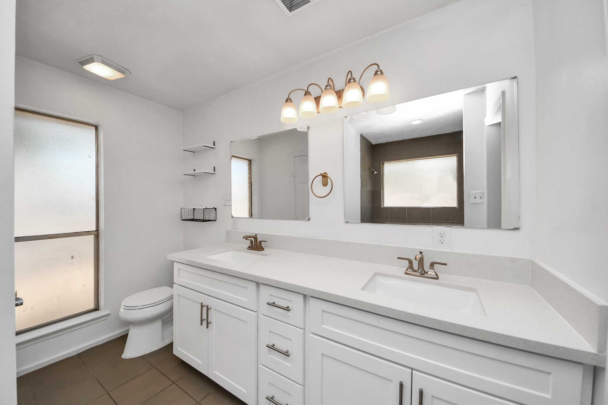 411 Dover Lane Spring, TX 77373 - Photo 28 of 40 a bathroom with a double vanity sink mirror and toilet