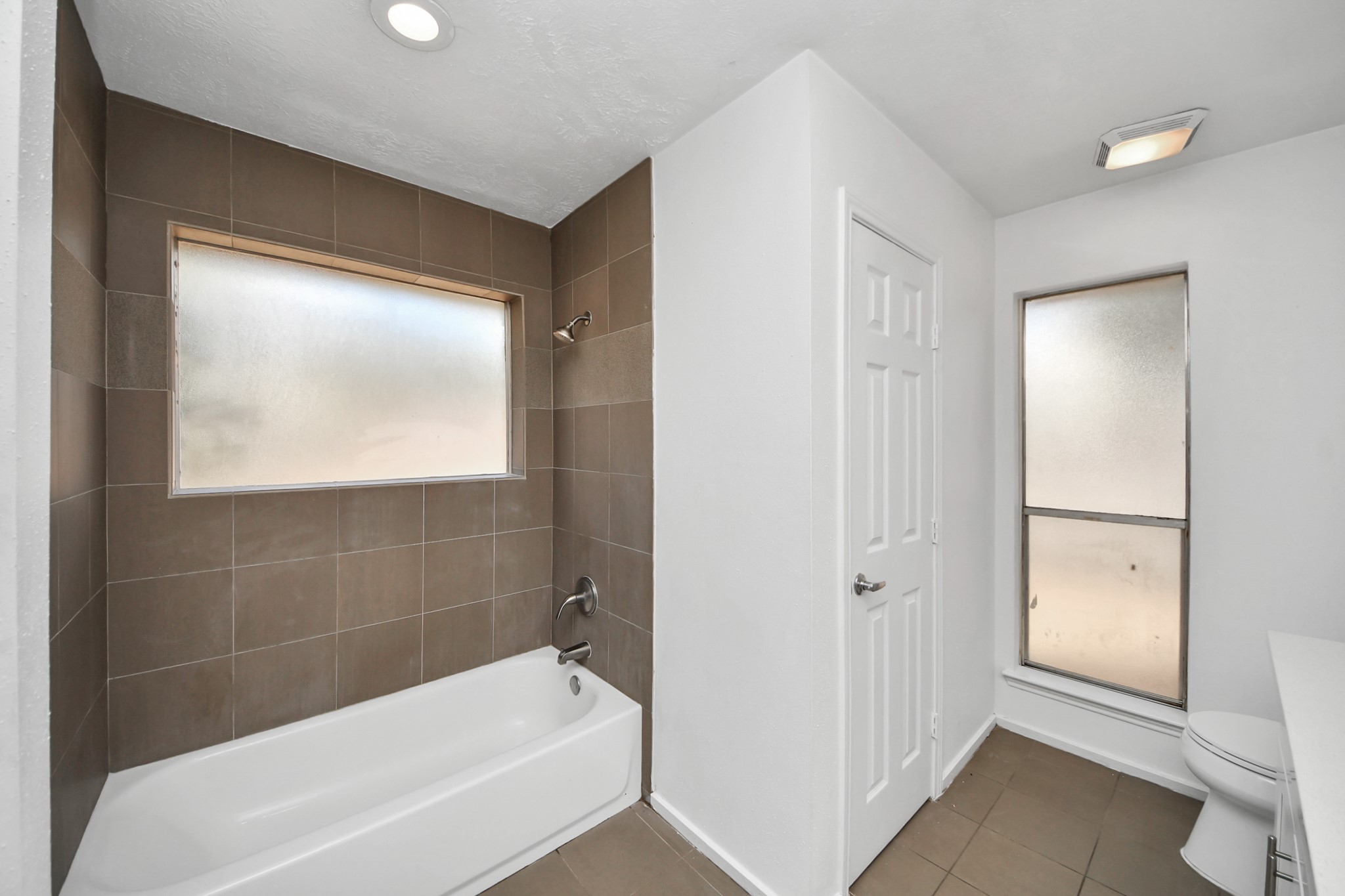 411 Dover Lane Spring, TX 77373 - Photo 29 of 40 a bathroom with a bathtub and a shower