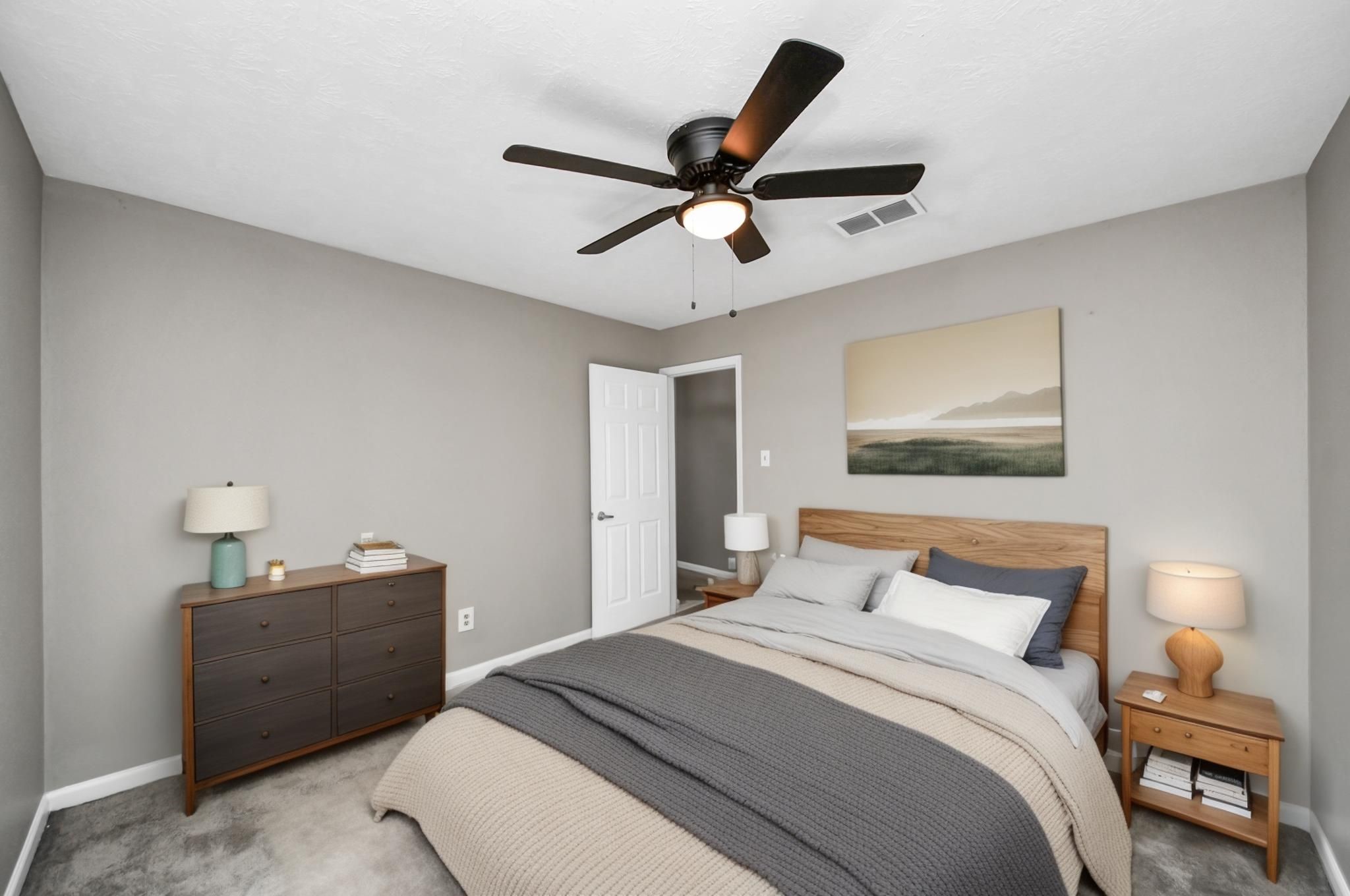 411 Dover Lane Spring, TX 77373 - Photo 31 of 40 a bedroom with a bed and a painting on the wall