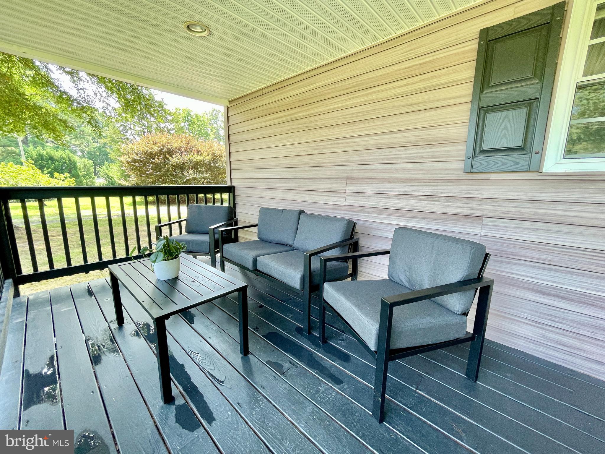 308 Apple Tree Road Montross, VA 22520 - Photo 12 of 55 a view of a wooden chairs on the deck
