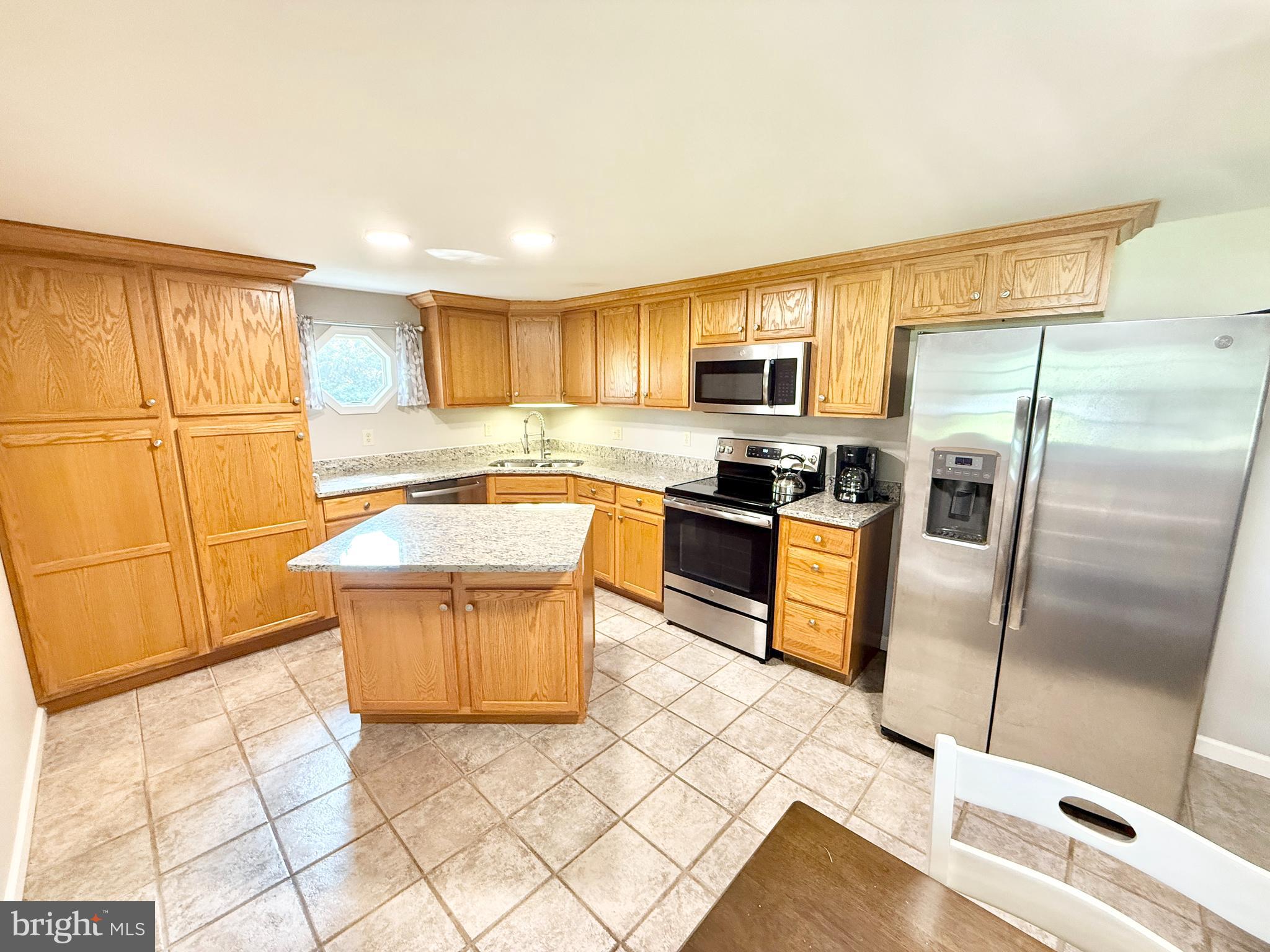 308 Apple Tree Road Montross, VA 22520 - Photo 20 of 55 a kitchen with stainless steel appliances granite countertop a refrigerator sink and stove