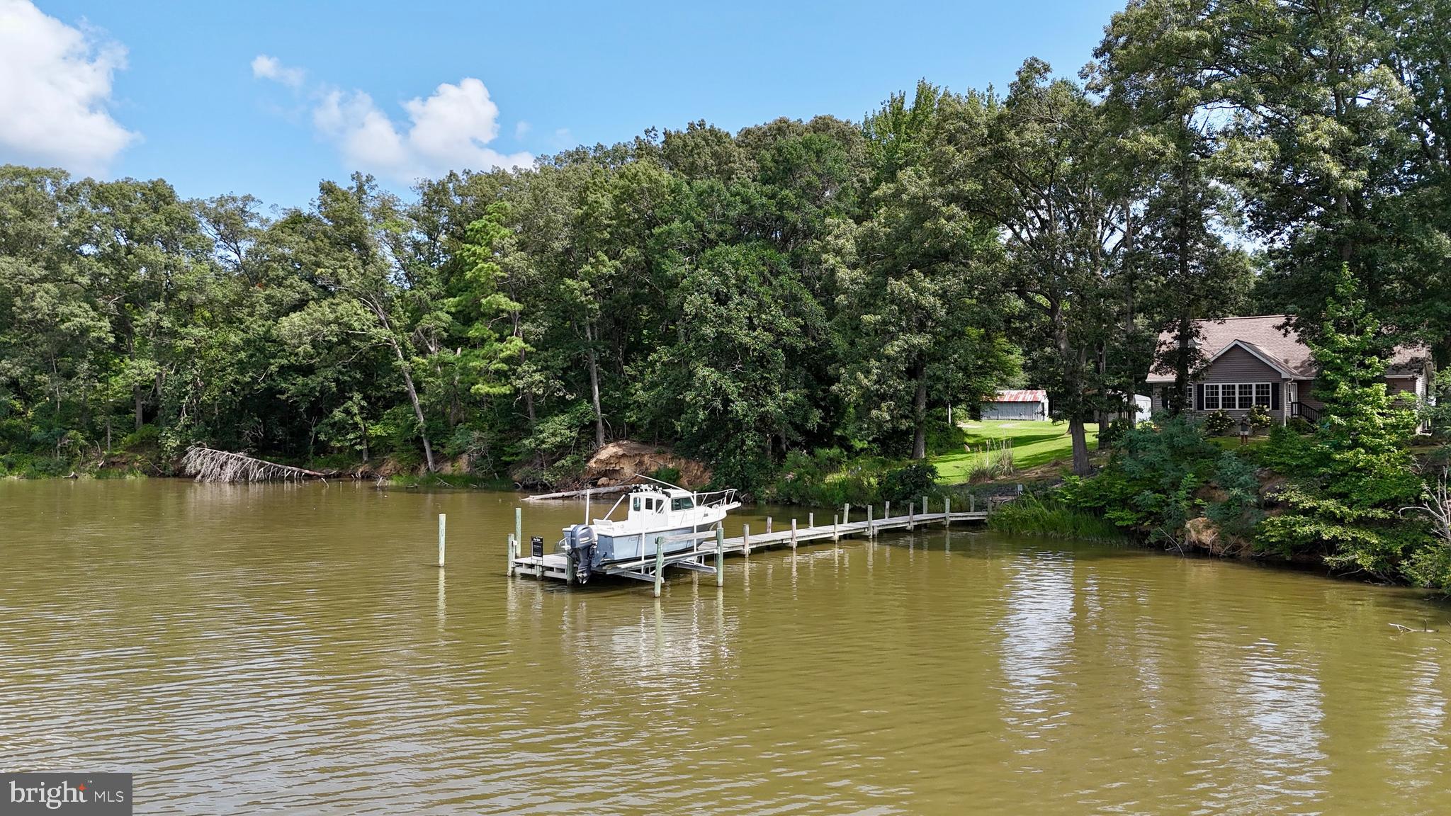 308 Apple Tree Road Montross, VA 22520 - Photo 2 of 55 a view of a lake with boats and trees in the background