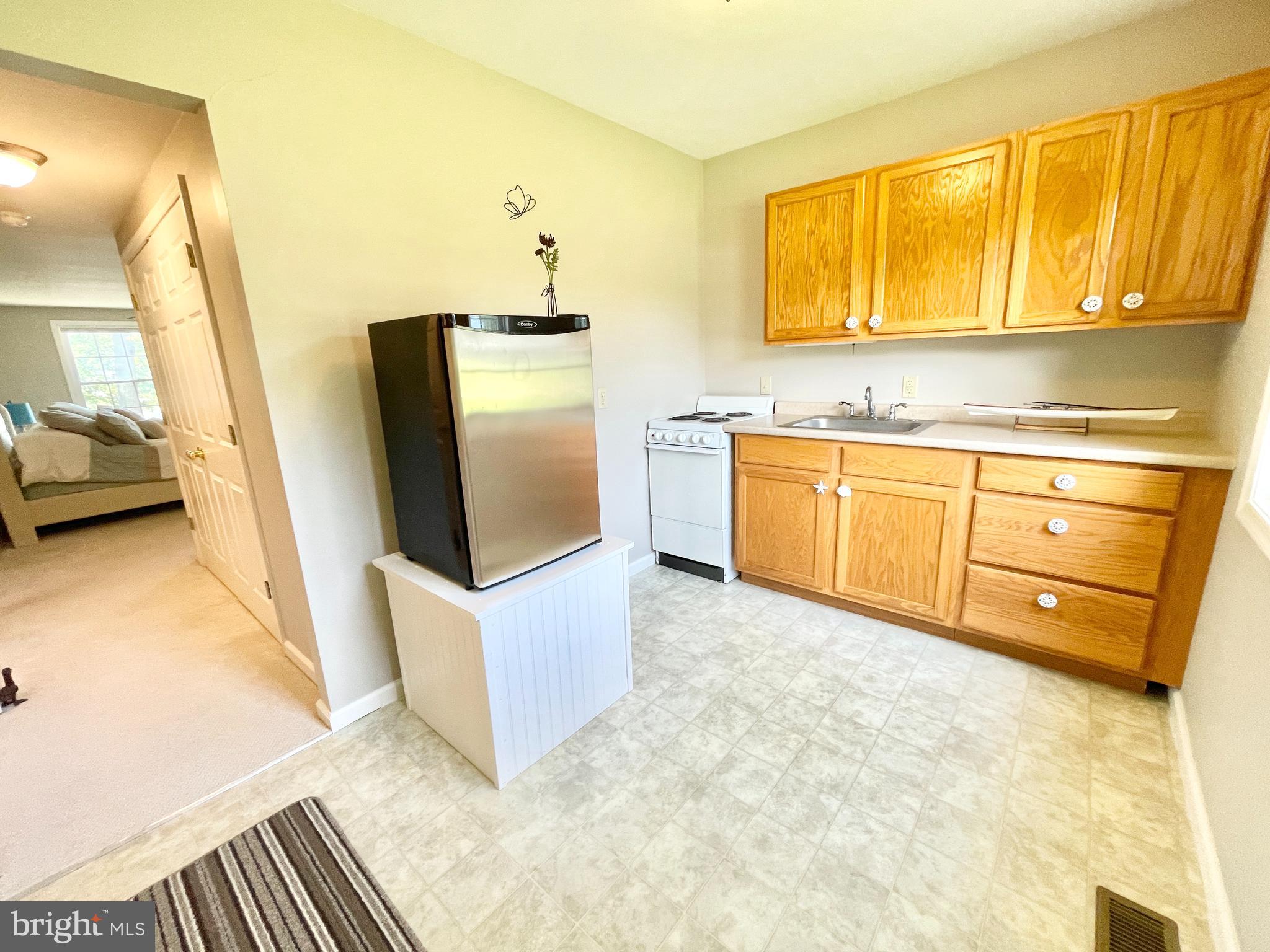308 Apple Tree Road Montross, VA 22520 - Photo 25 of 55 a kitchen with granite countertop a sink stainless steel appliances a counter top space and cabinets