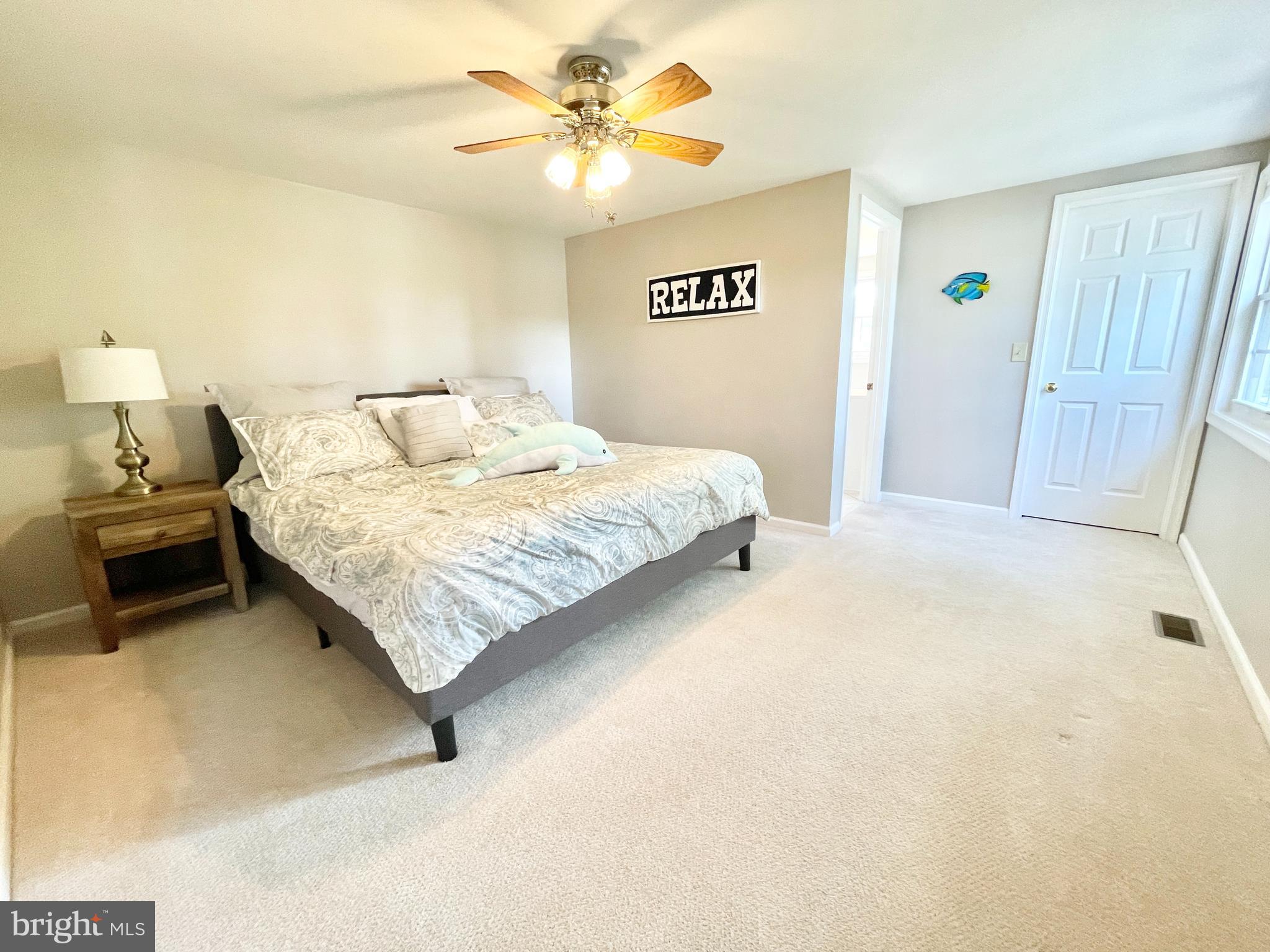 308 Apple Tree Road Montross, VA 22520 - Photo 27 of 55 a bedroom with a bed and a chandelier