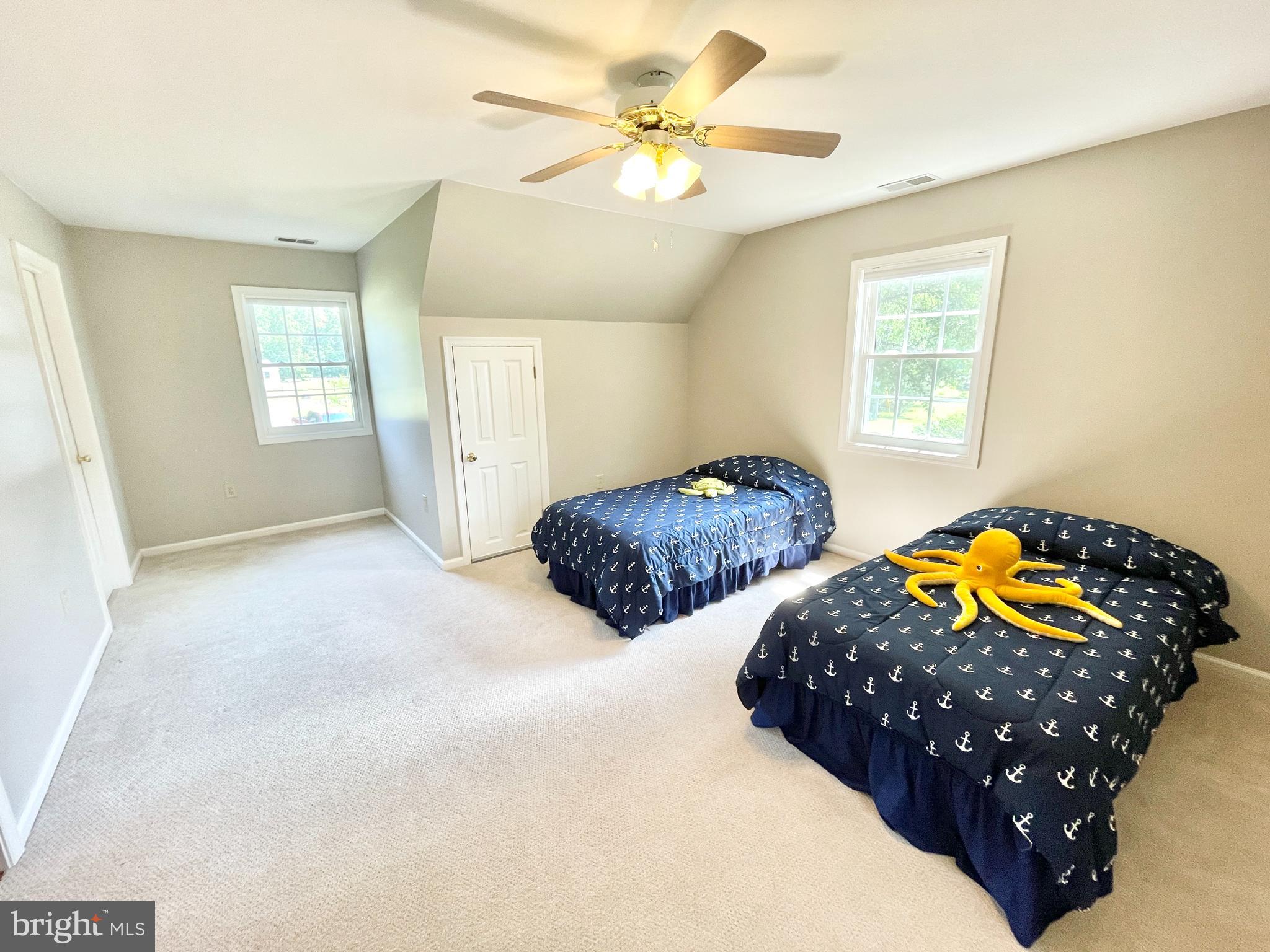 308 Apple Tree Road Montross, VA 22520 - Photo 31 of 55 a bedroom with bed and a chandelier