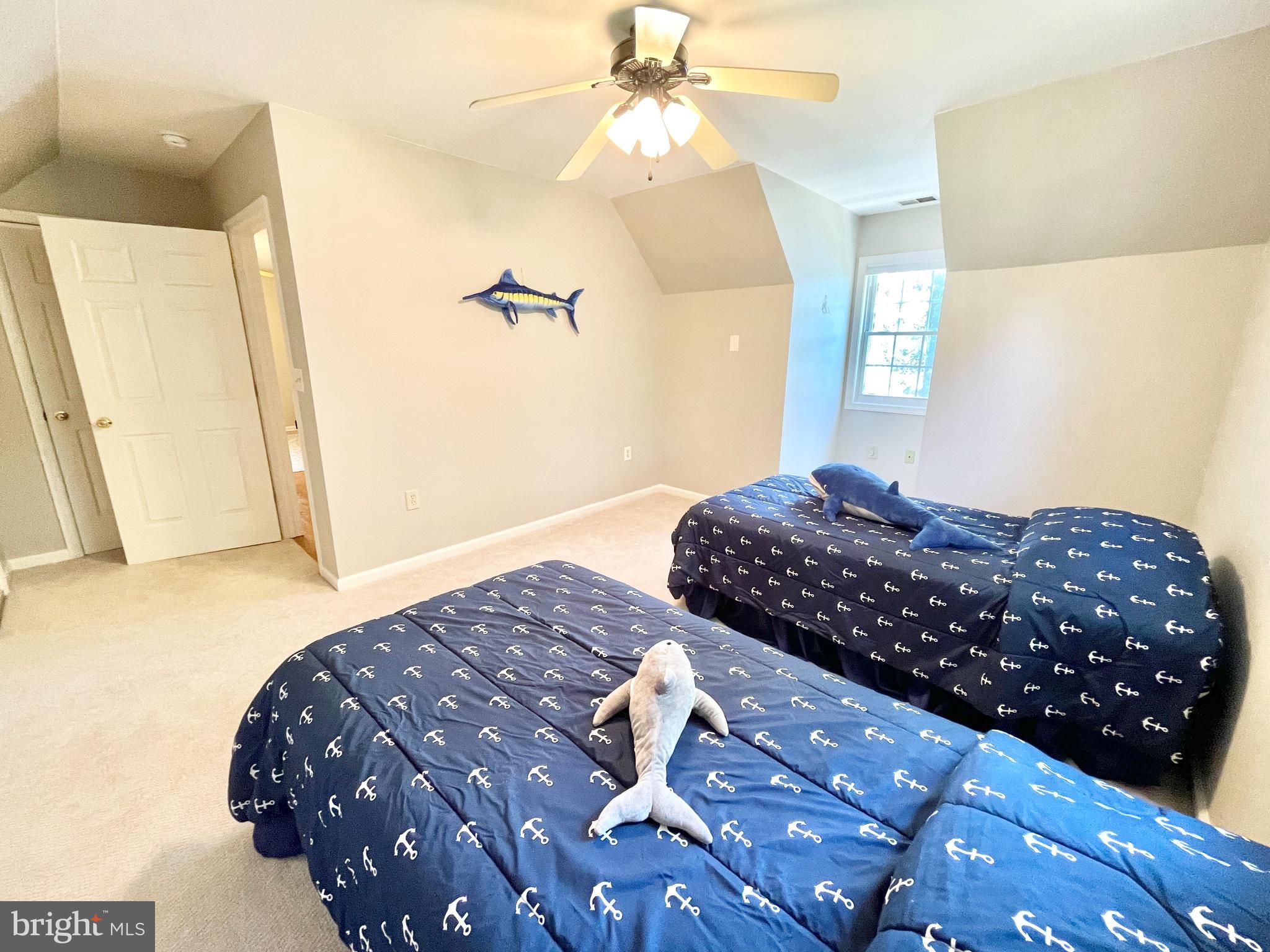 308 Apple Tree Road Montross, VA 22520 - Photo 34 of 55 a bedroom with a bed and a chandelier