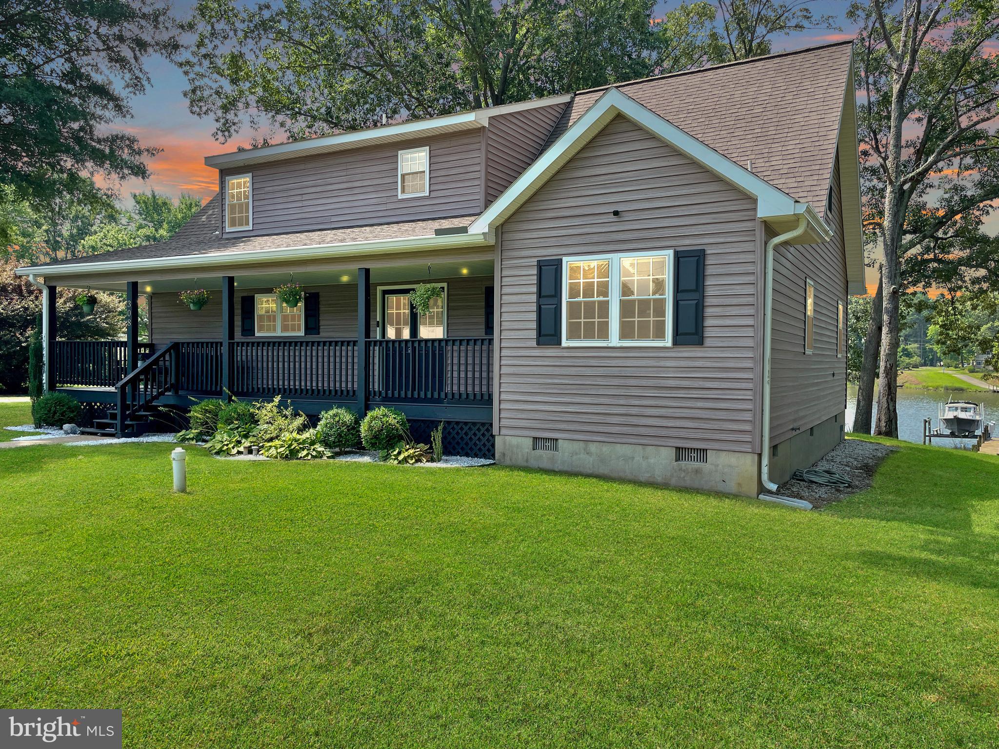 308 Apple Tree Road Montross, VA 22520 - Photo 7 of 55 a front view of a house with a yard and garden