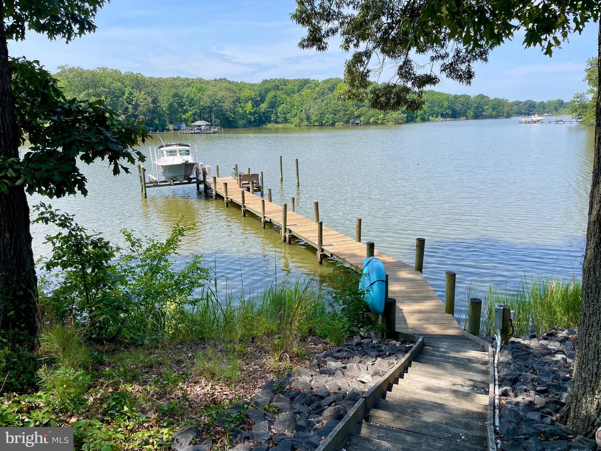308 Apple Tree Road Montross, VA 22520 - Photo 8 of 55 a view of a lake with a house in the background