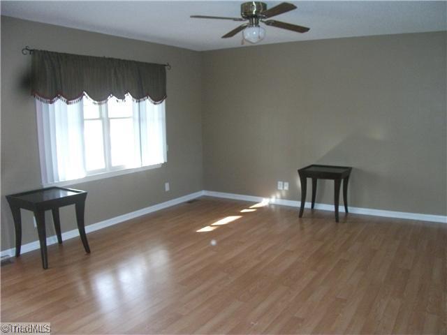 4406 Hunters Run Trinity, NC 27370 - Photo 2 of 15 Living Room. Beautiful laminate flooring. Lots of light!