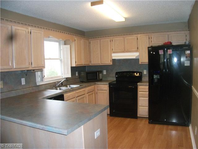 4406 Hunters Run Trinity, NC 27370 - Photo 4 of 15 Kitchen. Smooth top range, refrigerator and dishwasher. Breakfast bar.
